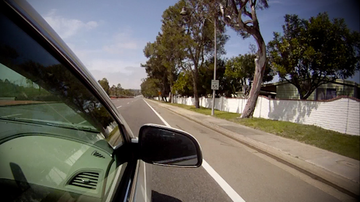 Drivin' 55 on County Highway S11...er, El Camino Real. Notice the houses on the other side of that fence?